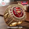 Gold Arsenal FC championship ring with red crystal, diamonds, and Premier League Champions text on wood background!