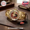Gold Arsenal FC watch with 2025-2026 Premier League Champions dial, player imagery, and metal band on leather background!