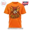 Bright orange t-shirt with a distressed vintage Buc-ees logo featuring a beaver in a cap on an iron cross graphic!
