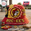 Red and yellow distressed bucket hat featuring Buc-ee's logo text and beaver mascot graphic on wooden surface!