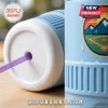 Top view of a white cooler lid with water droplets and a purple straw!