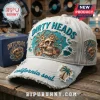 White distressed baseball cap with Dirty Heads text, skull, palm tree, and vinyl record embroidery in teal and orange!
