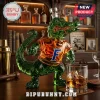Green glass alligator shaped liquor decanter wearing an orange shirt with a blue letter F logo on a wooden bar top!