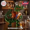 Green glass alligator shaped liquor decanter wearing an orange shirt with a blue letter F on a wooden bar top!