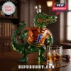 Green glass alligator decanter wearing orange shirt with blue letter F logo on wooden table with glass of whiskey!