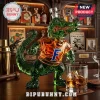 Green glass alligator decanter wearing an orange shirt with a blue F logo on a wooden bar top!