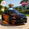 Amber and black Mustang car decanter with a gold crown topper on a marble surface.!