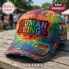 Tie-dye distressed baseball cap with Human Beings patch, rainbow flag, and Pride and Unity metal pin on wooden table!
