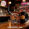 Iron Maiden 51st anniversary whiskey bottle with skull artwork, flaming details, and text 1975-2026 on wooden bar top!