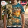 Vintage style Jimmy Buffett tee with 1977 Margaritaville text, parrot, guitar, and tropical sunset beach scene graphic print!