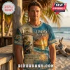 Jimmy Buffett Margaritaville t-shirt featuring tropical parrot guitar sunset design and 1977 text in blue and tan colors!