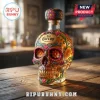 Jose Cuervo skull-shaped tequila bottle with colorful floral Day of the Dead art on a wooden surface!