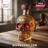 Jose Cuervo tequila bottle shaped like a decorative sugar skull with colorful floral motifs on a wooden table!