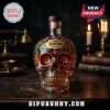 Glass skull-shaped tequila bottle with colorful floral designs and Jose Cuervo branding on a wooden table!