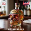 Clear skull-shaped Jose Cuervo Tequila bottle, gold liquid, vibrant Dia de los Muertos floral designs in pink, green, orange!