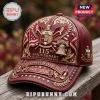 Burgundy Kappa Alpha Psi 115th anniversary baseball cap with gold embroidery, crest, and 1911-2026 text on leather surface!