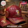 Maroon Kappa Alpha Psi baseball cap with gold emblem and Greek letters on a wooden desk with fraternity accessories!