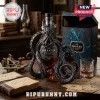 A Kraken rum bottle shaped like an octopus on a wooden desk with old navigational tools and books!