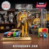 Kyle Busch M&Ms memorial figure with gold wings, trophy, and Toyota Camry race car in display case on wooden surface!