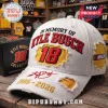 White Kyle Busch 18 NASCAR memorial hat with red text and distressed yellow patches on a wooden shop background!