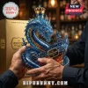 A close up of a detailed blue dragon and ship sculpture bottle for Leviathan Black Spiced Rum being held by a man.