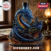 Blue glass dragon sculpture bottle featuring a ship and text reading The Leviathan Black Spiced Rum on wooden desk!