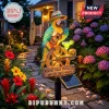 Solar garden light featuring a parrot in a hat playing ukulele with a sign saying Parrot Head Paradise Wastin Away Again!
