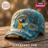 Distressed blue denim baseball cap featuring embroidered parrot in hat with sunglasses holding margarita and text JIMMY!
