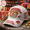 White distressed retro baseball cap with red 'NEBRASKA CORNHUSKERS' text and cartoon corn-surfing beach scene! 'SUN'S OUT, CORN'S UP!' on brim!