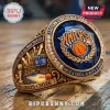 Gold New York Knicks championship ring with blue stone, text reads Eastern Conference Champions and 2025-2026!