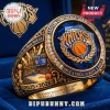 Gold New York Knicks championship ring with blue stone, basketball logo, and 2025-2026 text on blue velvet background!