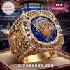 Gold New York Knicks 2026 championship ring with blue stone, crystal accents, and engraved NYC and basketball trophy design!