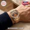 Gold watch with New York Knicks logo on face, blue and orange accents, crystal bezel on a man's wrist.!