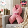 Pink ribbon shaped throw pillow with Breast Cancer Awareness Month embroidery on a grey sofa!