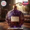 Purple glass bottle with gold swirl pattern and One Piece 30th Anniversary 1997-2027 label on wooden desk!