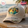 Distressed beige baseball cap features embroidered parrot, sunset beach, 