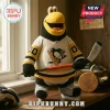 Plush hockey mascot wearing black yellow and white penguin jersey with hockey stick on wooden shelf at bipubunny.com!