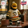 Plush penguin mascot wearing a yellow black and white hockey jersey holding a stick on a wooden shelf!