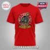 Red graphic t-shirt with cartoon Scooby-Doo dressed as a firefighter inside a red and gold emblem logo!