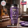 Purple metal tumbler with guitar graphics, Prince logo, and text Purple Rain Let is Go Crazy on wooden desk!