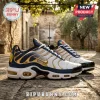 White, navy, and gold athletic sneakers with wavy pattern, gold swoosh, and cartoon character on heel!