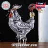 Clear glass rooster shaped liquor decanter with amber tail accents on a wooden table against a black background!