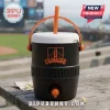 A black and orange insulated cooler jug with a Giants logo on a picnic table at a baseball stadium!