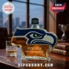 Seattle Seahawks logo shaped whiskey bottle, amber liquid, 1976-2026 50th Anniversary text on glass surface!