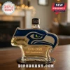 Seahawks logo shaped glass liquor bottle with 1976-2026 50th Anniversary text on a wooden table!