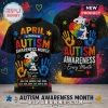 Black t-shirt with Snoopy holding a colorful puzzle heart and handprints with text about Autism Awareness Month!
