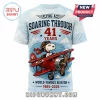 Light blue all-over print t-shirt featuring Snoopy as a Flying Ace in a red biplane with text 41 Years 1985-2026!