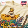 Cream tee with retro yellow submarine graphic, colorful psychedelic ocean waves, and guitar illustration on fabric!