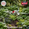 White and red classic airplane wind spinner garden decor with silver propellers and 'I-BHWU' text, amidst green plants and flowers!