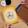 Yellow Disney Winnie the Pooh 100 Years passport holder with red balloon graphic in a hexagonal logo design!